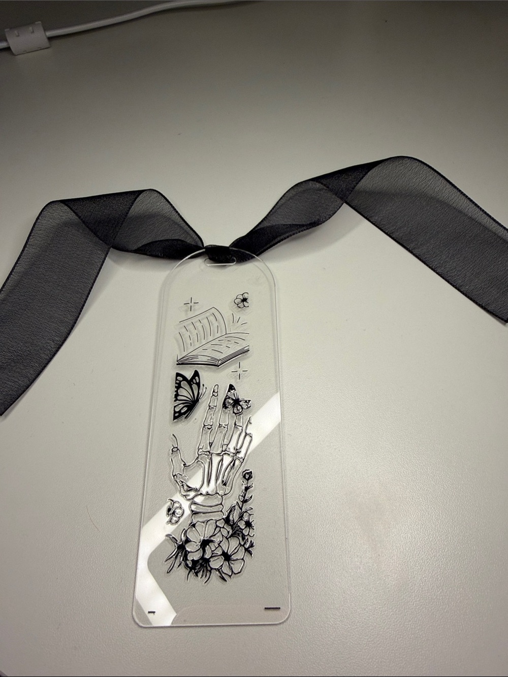 Black Ribbon Acrylic Bookmark with Skeleton Hand & Floral Design